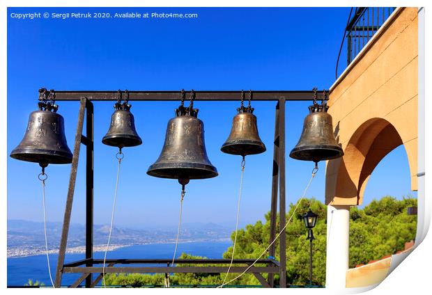 Closeup of bells against a blue sky, mediterranean pine and sea coast in blur, Greece, August 2019. Print by Sergii Petruk