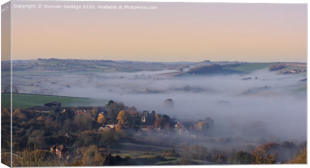 Autumnal mist of Englishcombe Village near Bath Canvas Print by Duncan Savidge