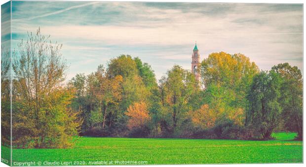 Large green field with trees and one bell tower. Canvas Print by Claudio Lepri