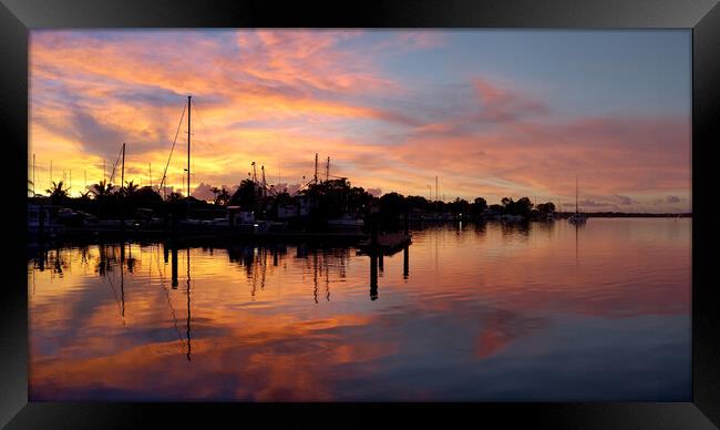 Sunrise silhouette Tin Can Bay. Framed Print by Geoff Childs