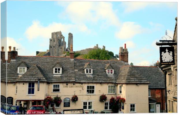 Corfe Castle from the town square in Dorset. Canvas Print by john hill