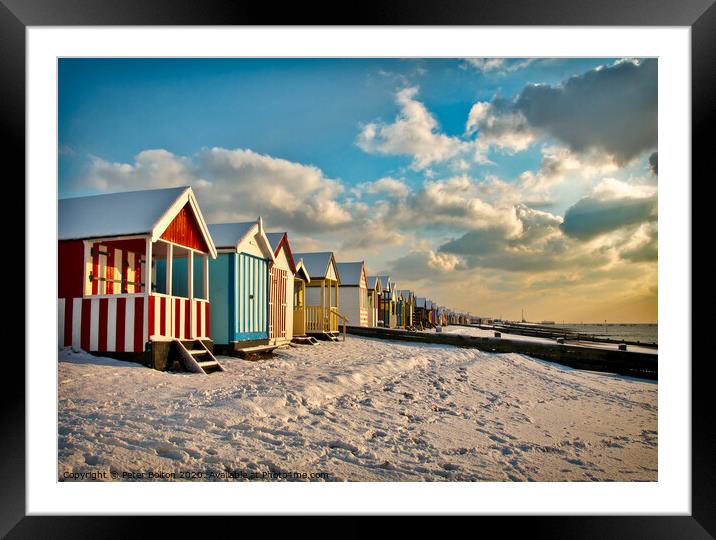 Beach huts at Thorpe Bay in winter with snow.  Framed Mounted Print by Peter Bolton