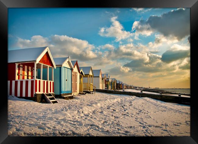 Beach huts at Thorpe Bay in winter with snow.  Framed Print by Peter Bolton