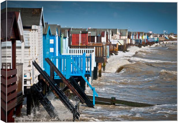 High tide at Thorpe Bay with beach huts. Canvas Print by Peter Bolton