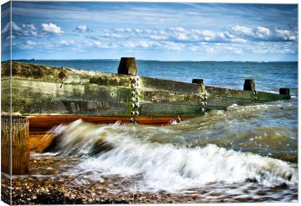 Waves crashing over a breakwater on the beach at Westcliff on Sea, Essex, UK Canvas Print by Peter Bolton