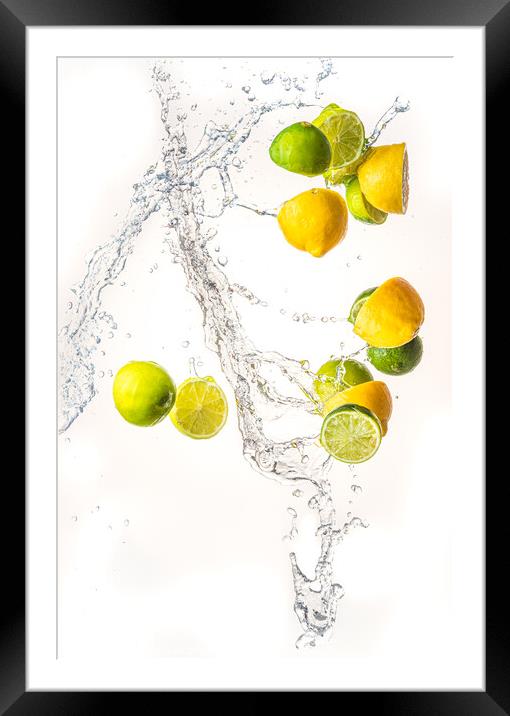 Fresh limes and lemons with water splash in midair, isolated on white background Framed Mounted Print by Przemek Iciak