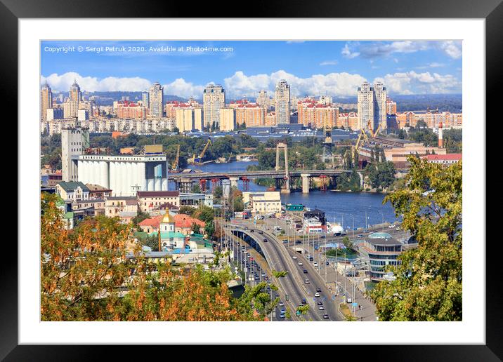 The landscape of the autumn city of Kyiv with a view of the Dnipro River, many bridges, the old Podilsky district and new houses on Obolon. Framed Mounted Print by Sergii Petruk