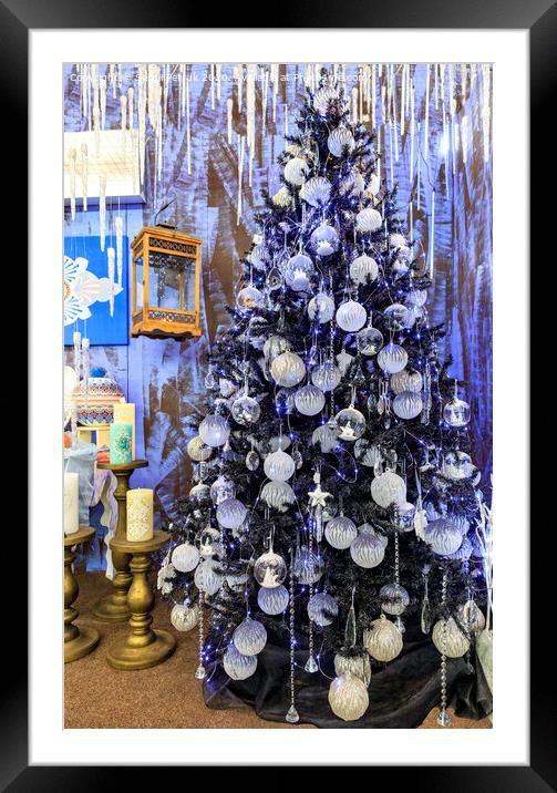 Christmas toys and stars, Christmas tinsel, decorative icicles and blue lights hang on a Christmas tree. Framed Mounted Print by Sergii Petruk