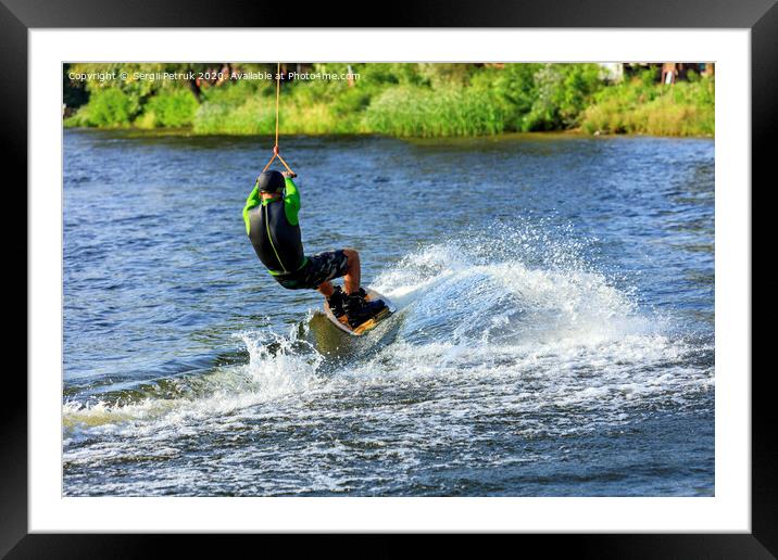 A wakeboarder rushes through the water at high speed along the green bank of the river. Framed Mounted Print by Sergii Petruk