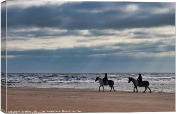 Horseriders on a Winter Beach Canvas Print by Mike Dale