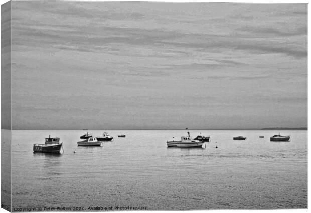 Black and white study of small boats at anchor offshore at Thorpe Bay, Essex. Canvas Print by Peter Bolton