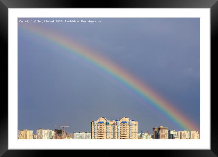 Rainbow in the sky above the city after a thunderstorm. Framed Mounted Print by Sergii Petruk