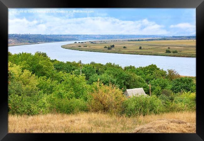 View of the roof of a rural house and the Southern Bug River from a hill. Framed Print by Sergii Petruk