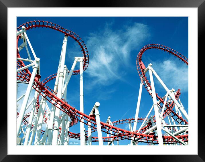 Roller coaster loops against a blue sky at Ingoldmells in Skegness. Framed Mounted Print by john hill