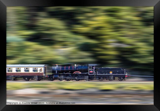 A train in motion  Framed Print by Freddie Street