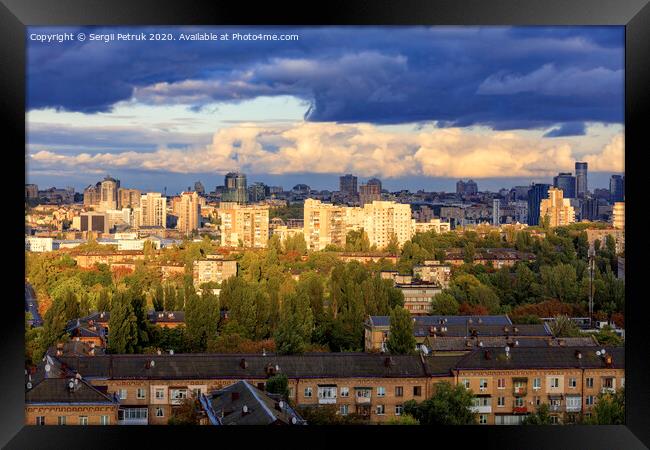 The beautiful light of the setting sun falls on the houses in the city landscape. Framed Print by Sergii Petruk