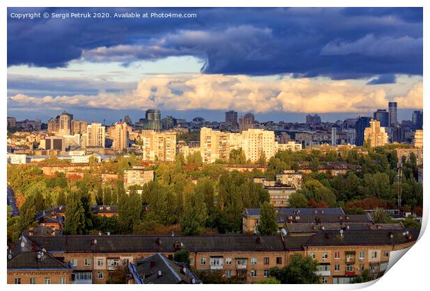 The beautiful light of the setting sun falls on the houses in the city landscape. Print by Sergii Petruk