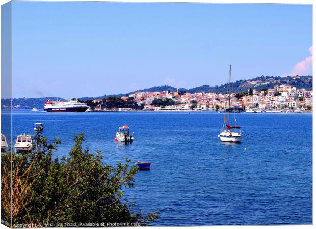 Skiathos town from across the bay on Skiathos Island in Greece. Canvas Print by john hill