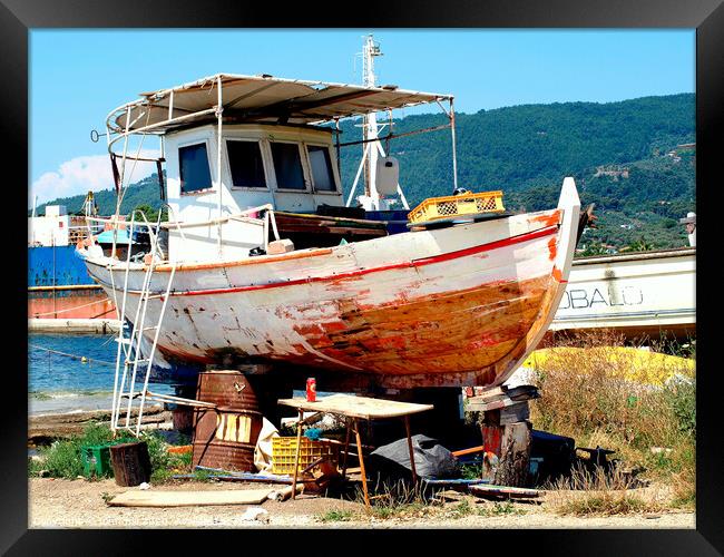 Greek fishing boat having service in Dry dock. Framed Print by john hill
