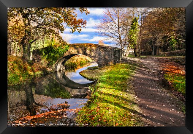 Neath canal and bridge in autumn Framed Print by Peter Thomas