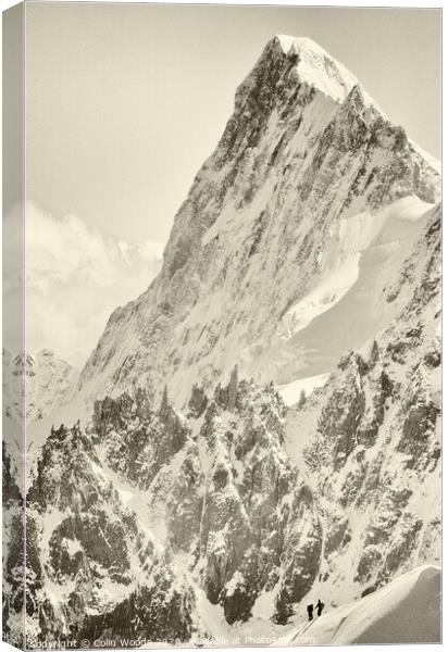 The tiny figure of a climber in front  of the Grandes Jorasses Canvas Print by Colin Woods