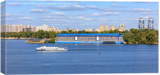 Landscape: pleasure ships go along the Dnipro River against the background of residential areas of Kyiv on the banks in bright sunlight. Canvas Print by Sergii Petruk