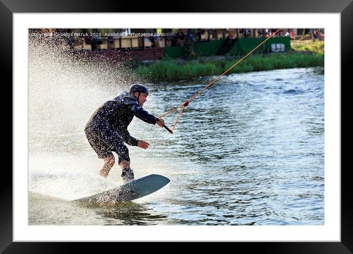 Wakeboarder rushes through the water at high speed along the grassy banks of the river. Framed Mounted Print by Sergii Petruk