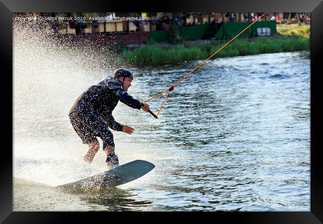 Wakeboarder rushes through the water at high speed along the grassy banks of the river. Framed Print by Sergii Petruk