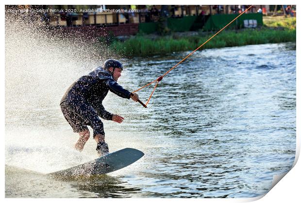 Wakeboarder rushes through the water at high speed along the grassy banks of the river. Print by Sergii Petruk