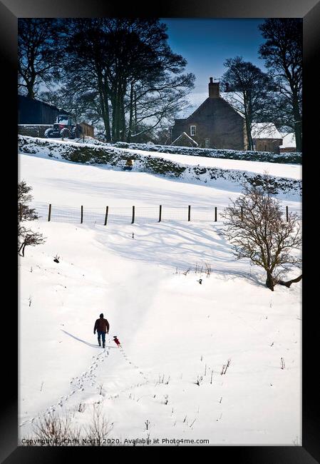 One man and his dog, a winter walk. Framed Print by Chris North