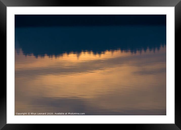Reflection of sunset colors over trees in calm rippled water Framed Mounted Print by Rhys Leonard