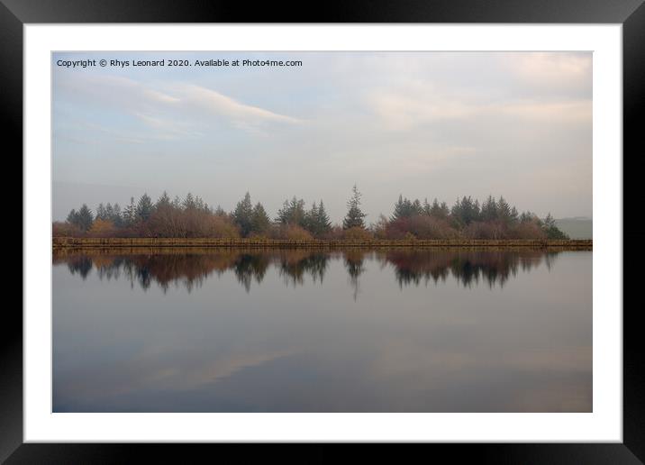 Dim evening light reflects autumn trees and redmires reservoir wall. Framed Mounted Print by Rhys Leonard