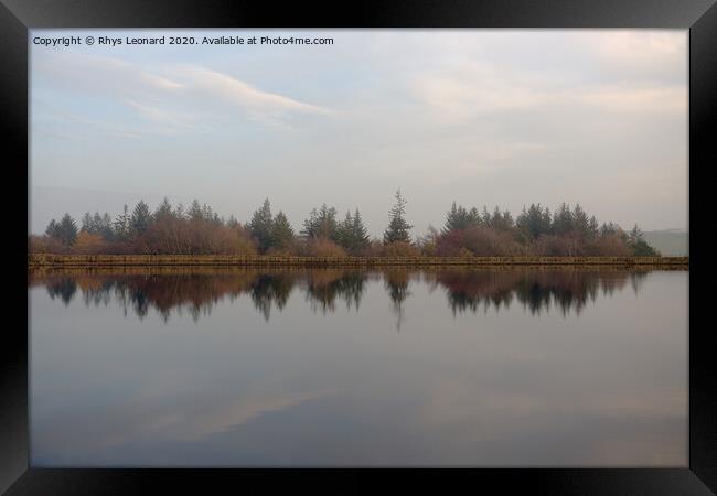 Dim evening light reflects autumn trees and redmires reservoir wall. Framed Print by Rhys Leonard