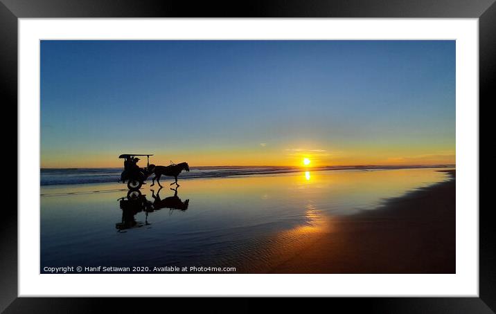 Silhouetted horse-drawn carriage beach sunset 1 Framed Mounted Print by Hanif Setiawan