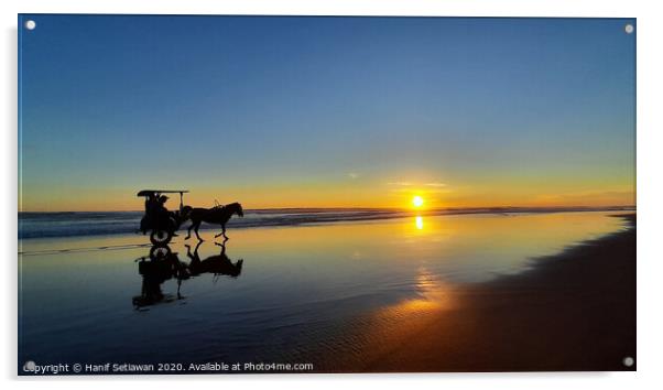 Silhouetted horse-drawn carriage beach sunset 1 Acrylic by Hanif Setiawan