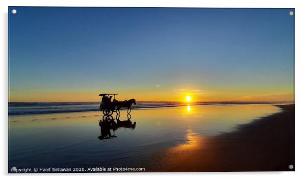 Silhouetted horse-drawn carriage beach sunset 1 Acrylic by Hanif Setiawan