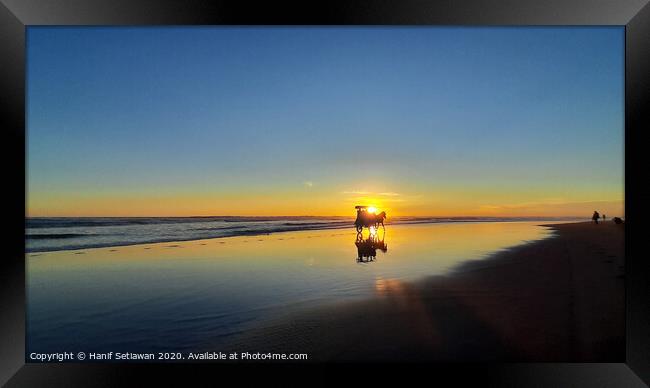 Silhouetted horse-drawn carriage beach sunset 3 Framed Print by Hanif Setiawan