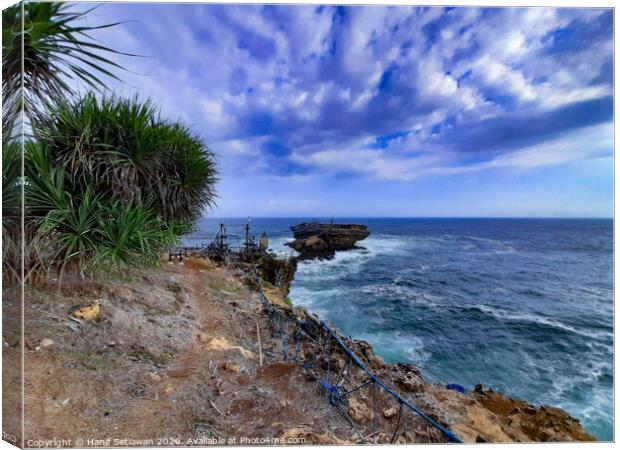 A rock plateau and a rock island in the sea 6 Canvas Print by Hanif Setiawan