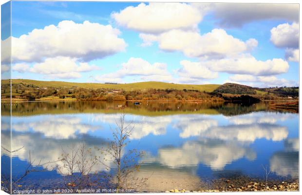 Cloud reflections in Carsington Water in Derbyshire. Canvas Print by john hill