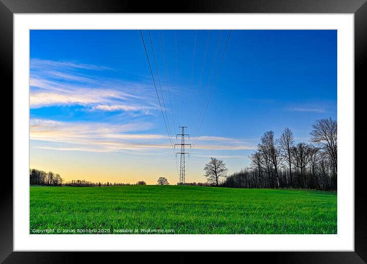 green field and blue sky with electric cables Framed Mounted Print by Jonas Rönnbro