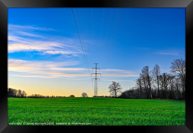 green field and blue sky with electric cables Framed Print by Jonas Rönnbro