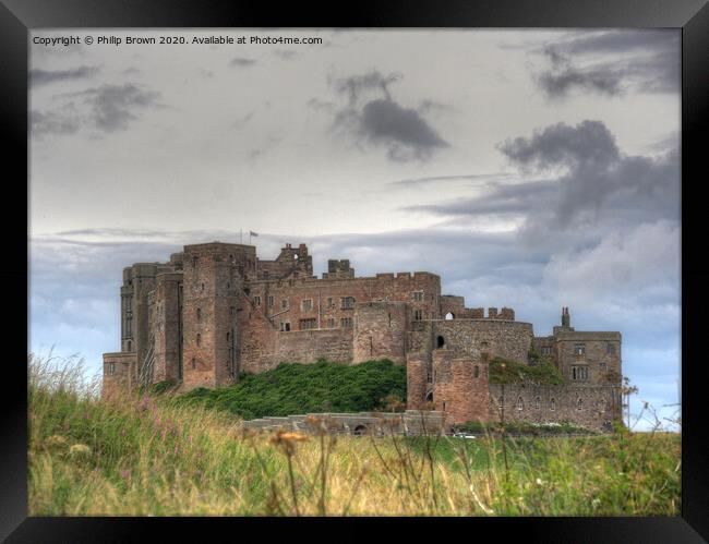 Bamburgh Castle in Northumberland Framed Print by Philip Brown