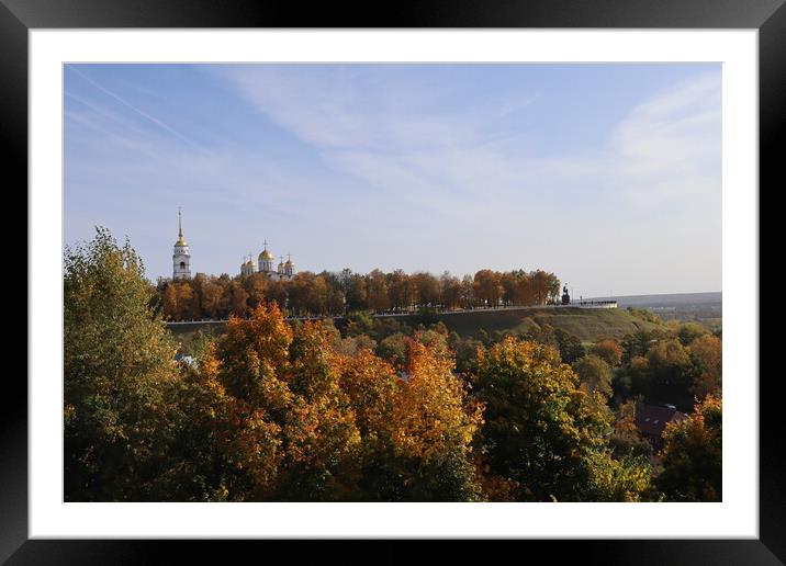 Stunning autumn landscape, top view, sun and blue sky, yellow trees, white Church, Golden domes, green grass, red leaves.  Framed Mounted Print by Karina Osipova