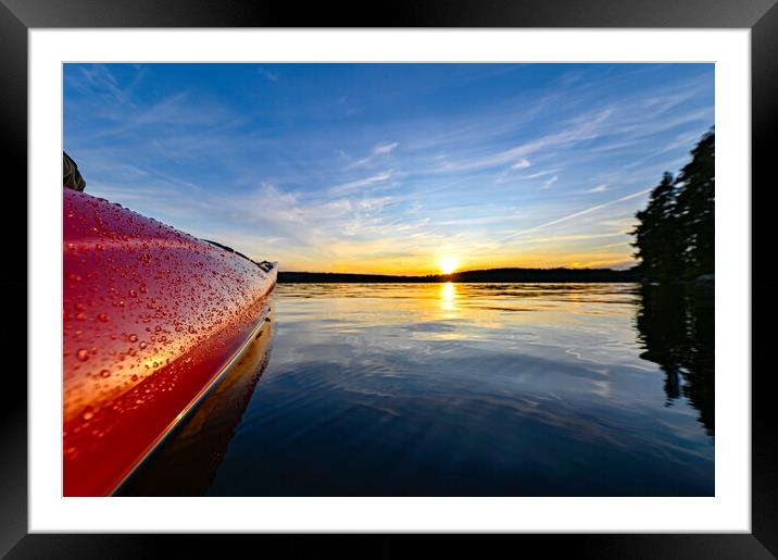 red plastic kayak on calm water in the sunset Framed Mounted Print by Jonas Rönnbro