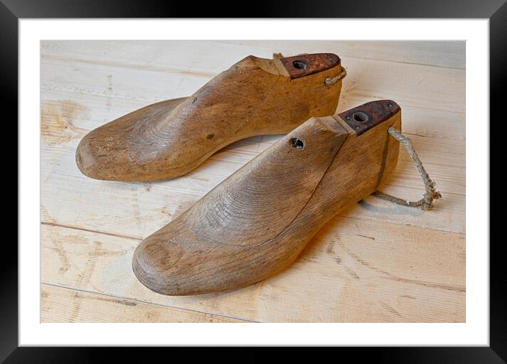 vintage wooden shoe lasts standing on wooden bench Framed Mounted Print by Jonas Rönnbro
