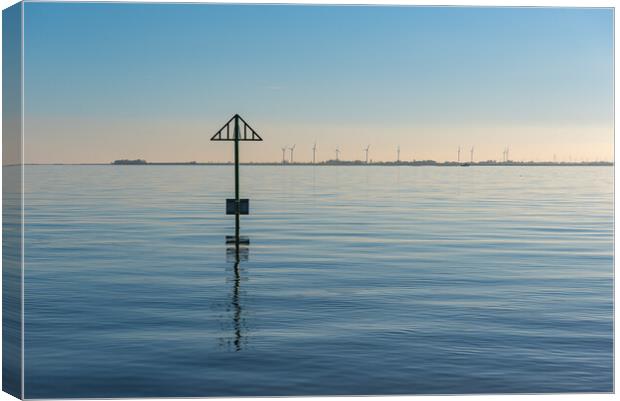 Seashore marker post and wind turbines Canvas Print by Gary Eason