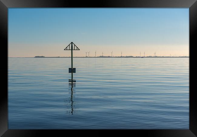 Seashore marker post and wind turbines Framed Print by Gary Eason
