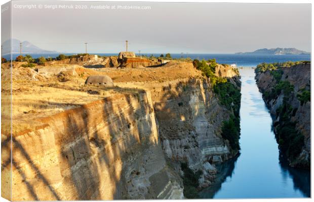 Coastal fortifications of the Corinth Canal in Greece in the bright rays of the morning rising sun. Canvas Print by Sergii Petruk