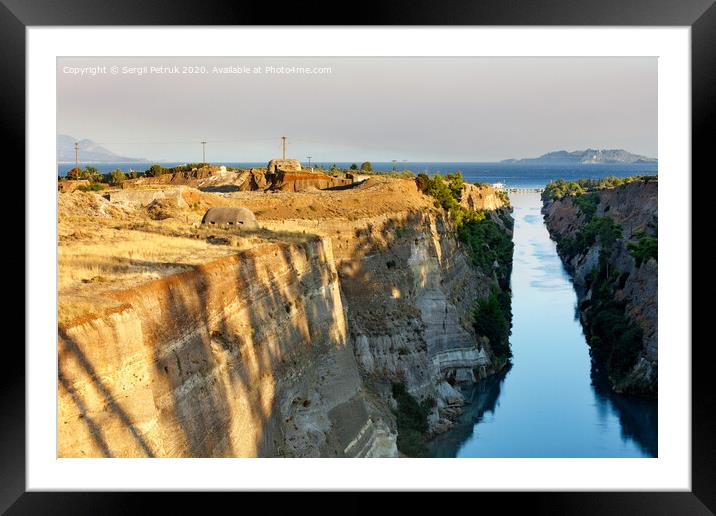 Coastal fortifications of the Corinth Canal in Greece in the bright rays of the morning rising sun. Framed Mounted Print by Sergii Petruk
