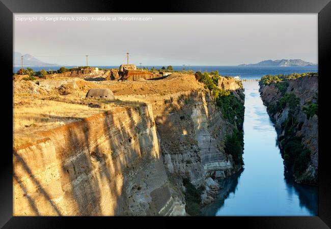 Coastal fortifications of the Corinth Canal in Greece in the bright rays of the morning rising sun. Framed Print by Sergii Petruk